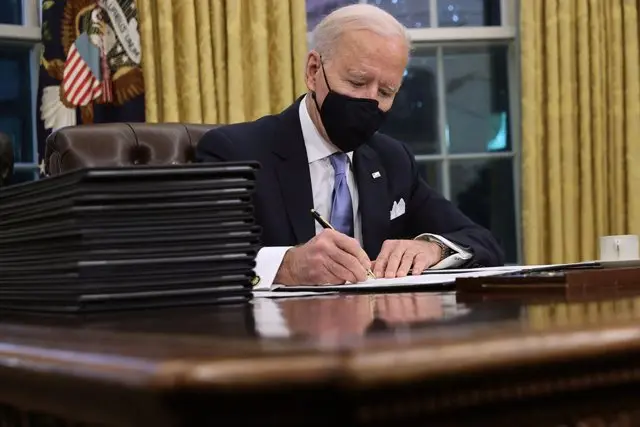 El presidente de Estados Unidos, Joe Biden, en el Despacho Oval de la Casa Blanca firmando &oacute;rdenes ejecutivas. / Voz de Am&eacute;rica