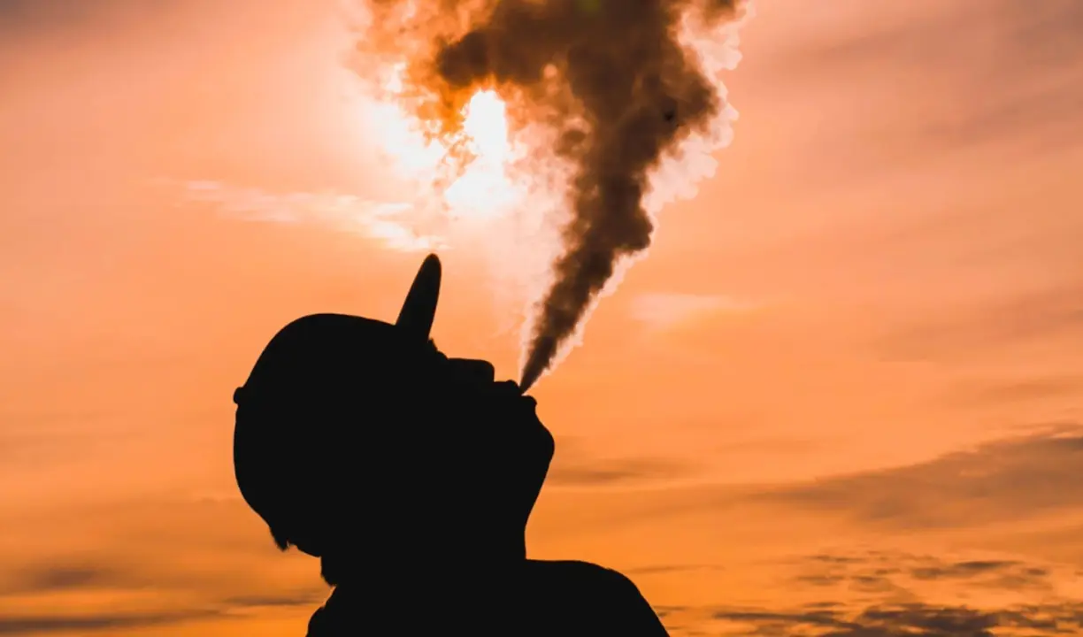 Un hombre echando humo. / Unsplash.