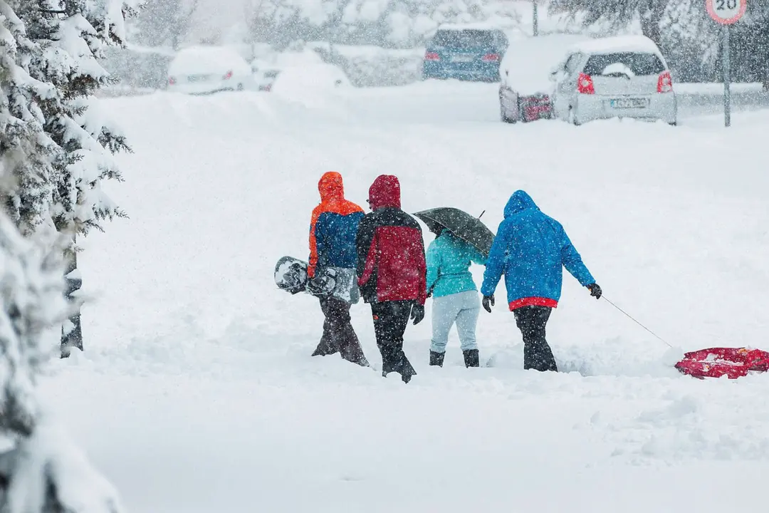 Unas personas bajo la nieve. / Pixabay.