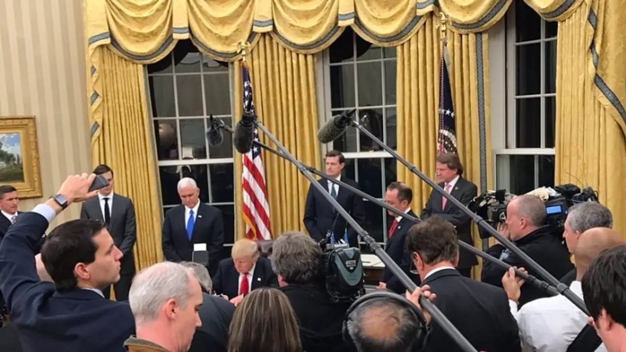 Donald Trump firma contra el Obamacare.