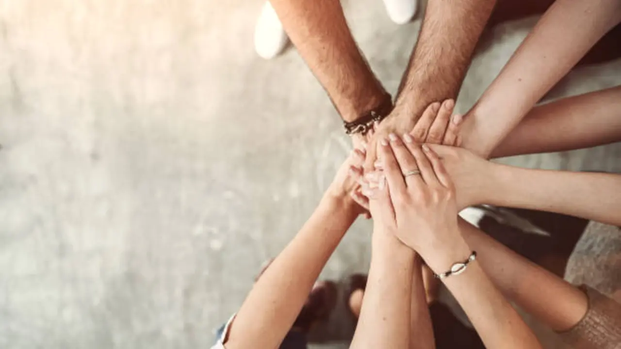 Teamwork, unity concept, group of friends put their hands together with copy space